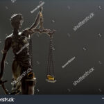 stock-photo-divorce-concept-wedding-rings-and-statue-of-justice-themis-1025539132