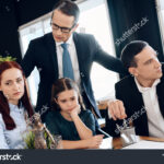 stock-photo-lawyer-calms-family-down-with-little-girl-who-gets-divorced-family-in-office-of-family-lawyer-1055292443